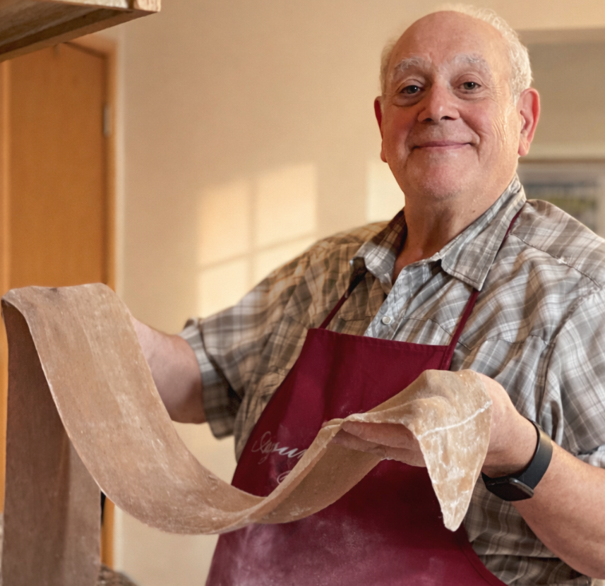 Closeup of cannoli with thin orange peel garnish.